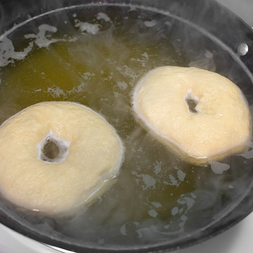 Boiling artisan bagels.