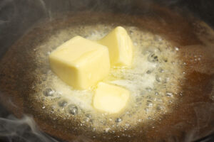 Melt Butter for Rustic Homemade Cornbread Tuesday, July 18, 2023.