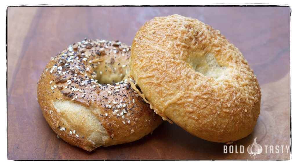 Artisan bagels, to the left is an everything bagel, and to the right is an asiago cheese bagel.